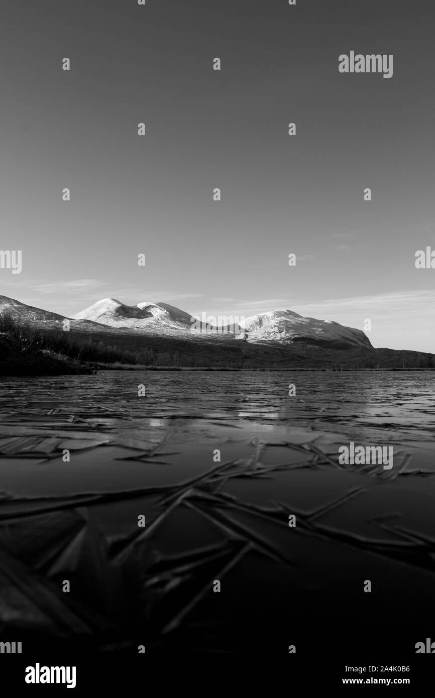 Snowy mountains at a cold lake Stock Photo