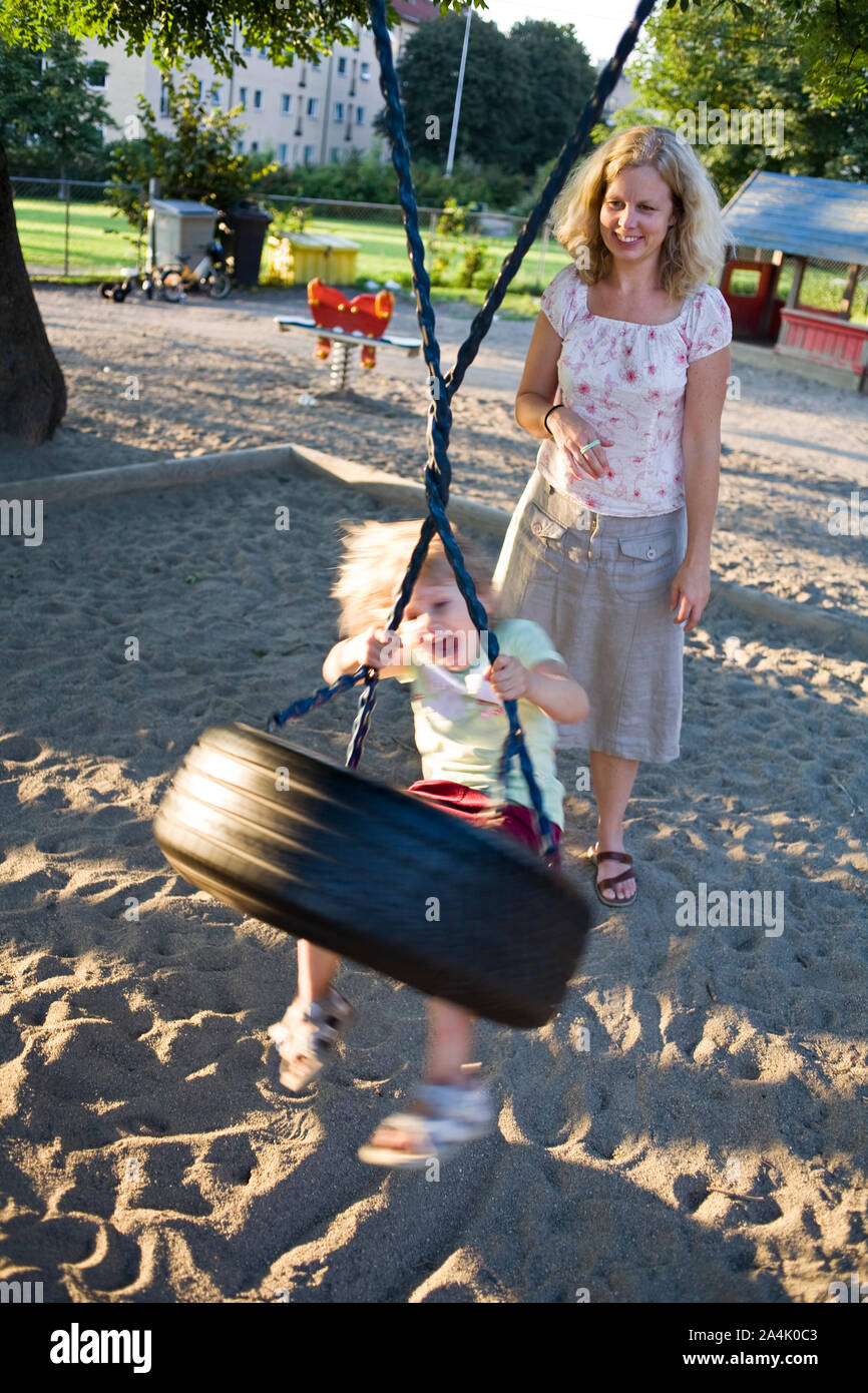 Child playing with swing Stock Photo