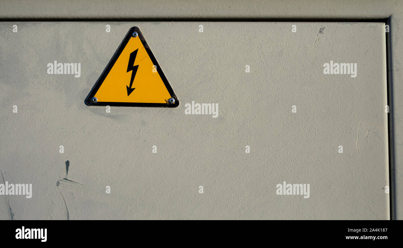 Electrical panel with label and danger signal identifying the risk of electric shock or yellow and black electrical shunt Stock Photo
