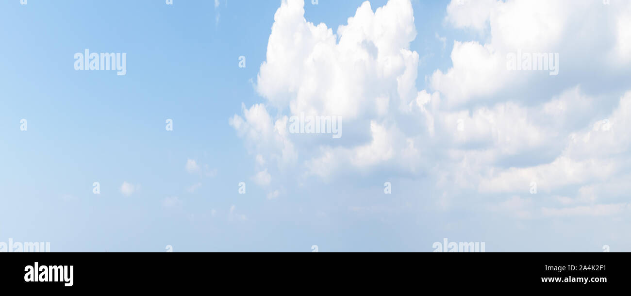 White cumulus clouds in bright blue sky at daytime. Natural panoramic ...