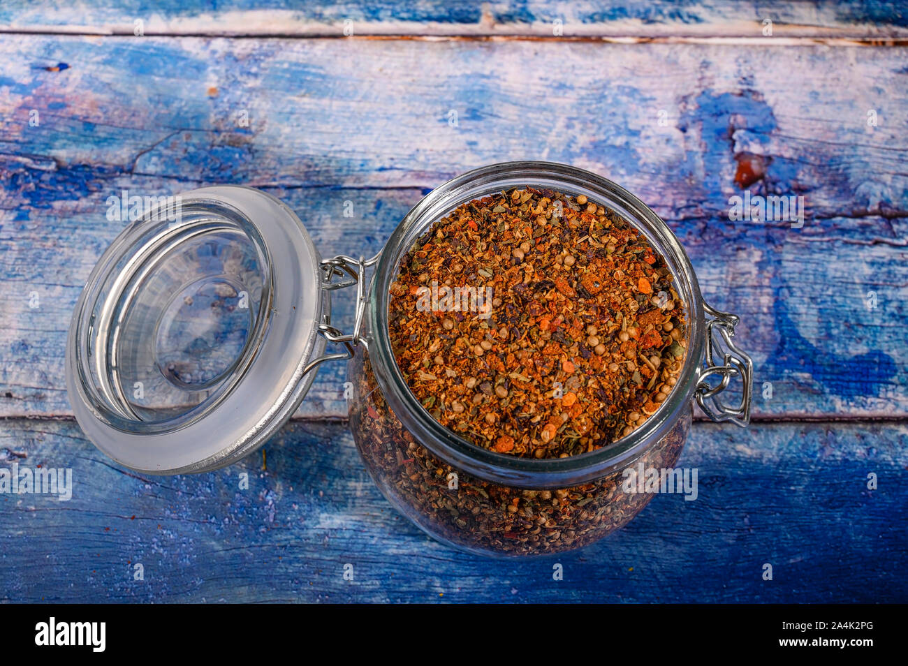 Fragrant spices in a glass jar with a lid and a metal lock. Close up