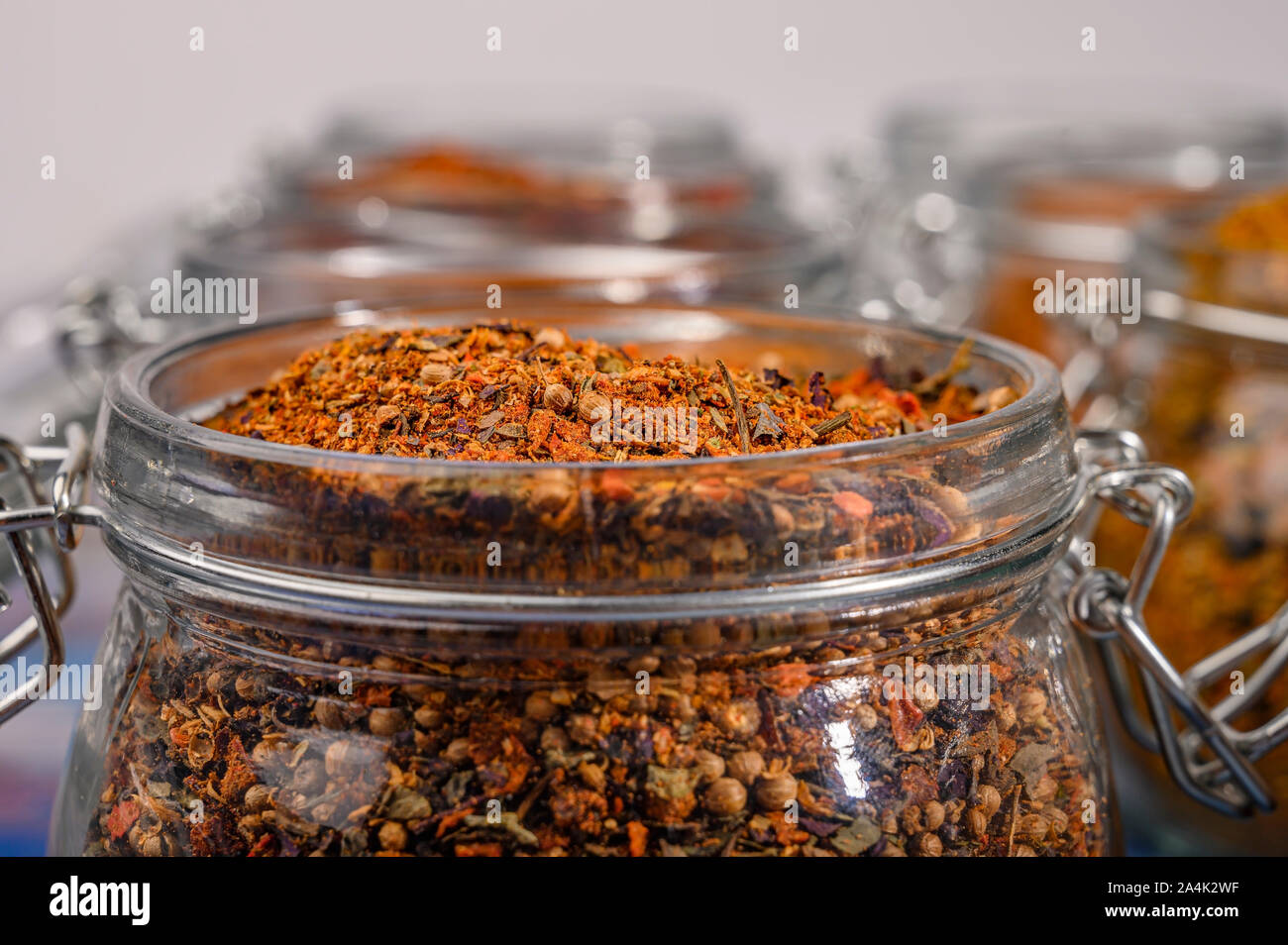Fragrant spices in a glass jar with a lid and a metal lock. Close up