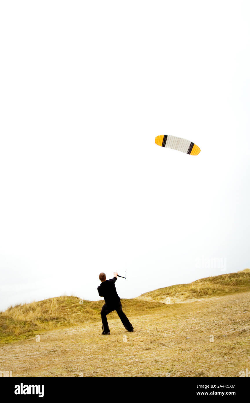 Man pulling kite Stock Photo