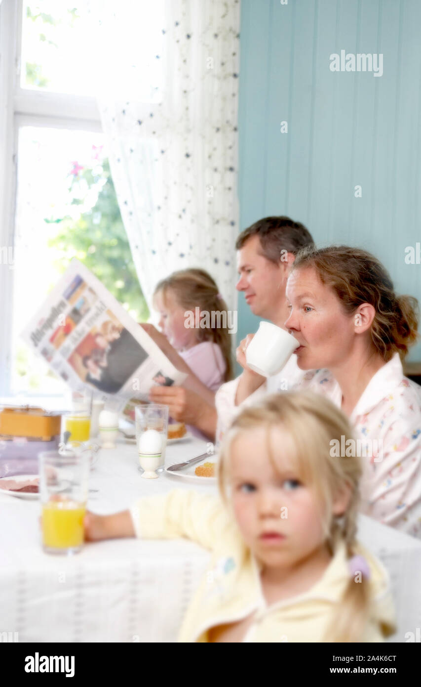 Family breakfast - goatcheese, orange juice and egg on the table. Stock Photo