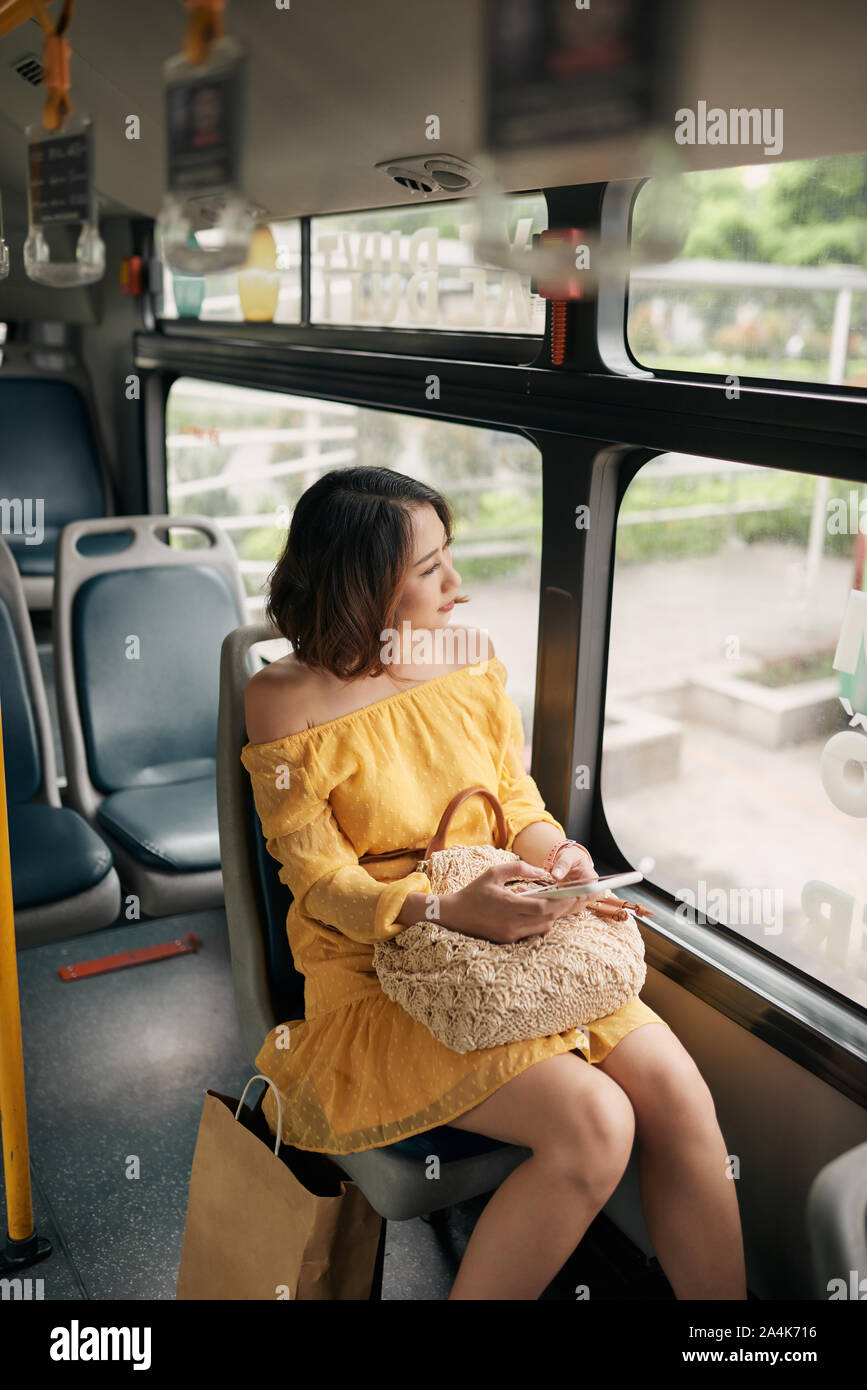 Asian woman looking view outside the bus window. Stock Photo