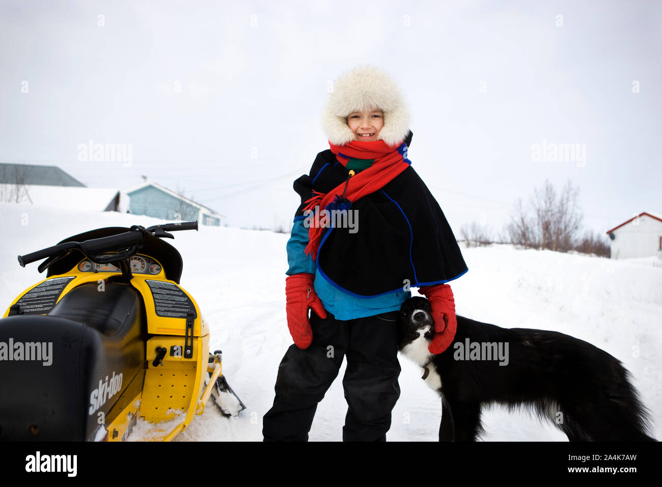 Lapp boy beside a snowmobile Stock Photo