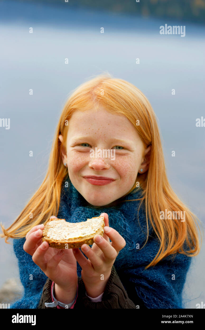 Girl eating outdoors stock photo alamy