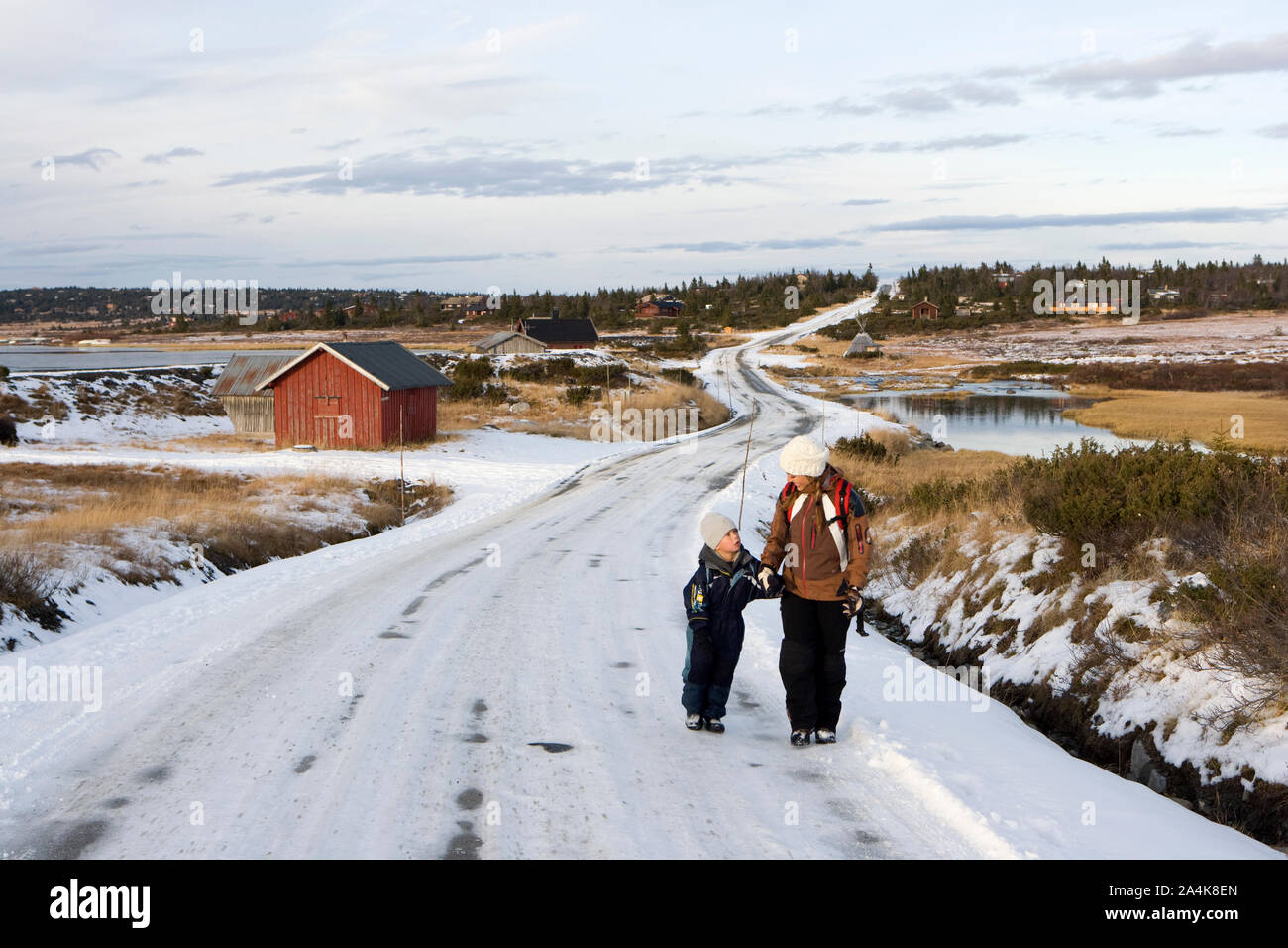 Children walking along desolated country road to school Stock Photo