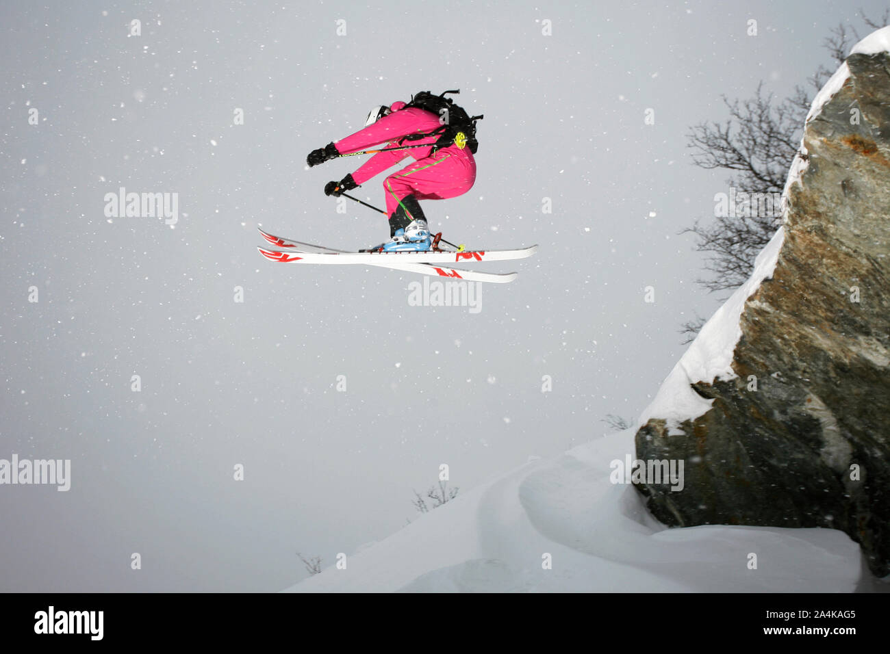 Woman jumping with skis Stock Photo