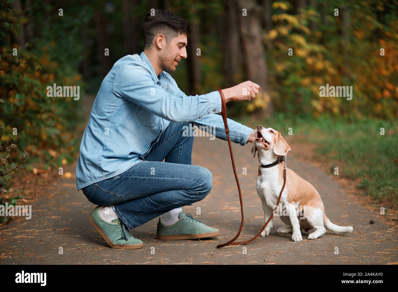 young good looking man training his petto perform some actions, full length side view photo Stock Photo