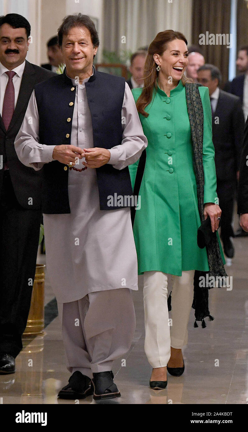 The Duchess of Cambridge walks alongside the Prime Minister of Pakistan Imran  Khan during a visit to his official residence in Islamabad on the second  day of the royal visit Stock Photo -