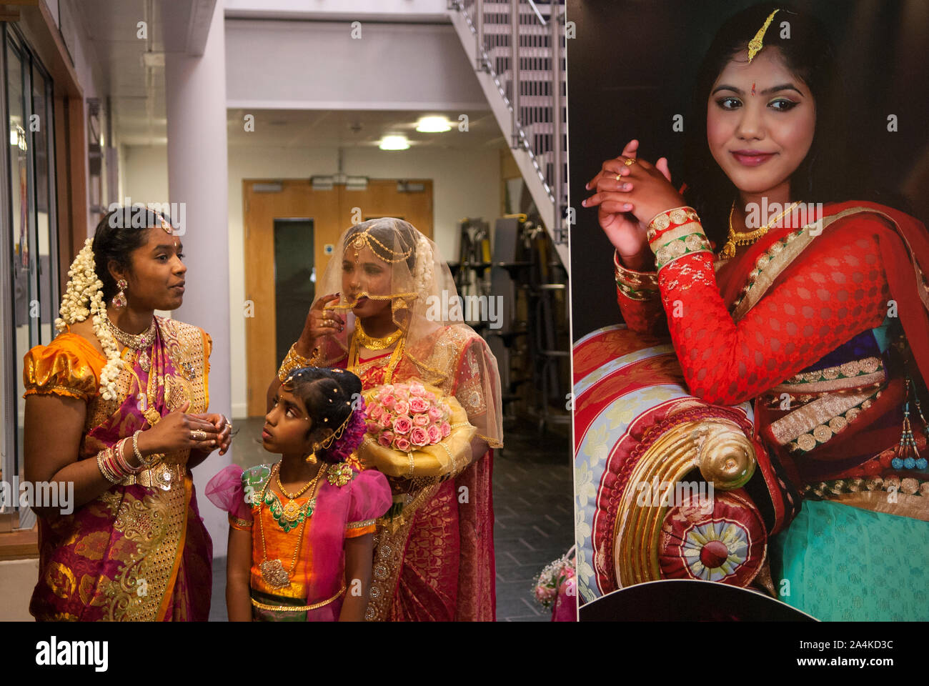 Hindu Coming of Age celebration party London Uk The display photograph is of the young woman. She is on the left wearing a veil for the first time with relatives. She is 16yrs old. Mitcham south London Uk They  are welcoming guests to the very big Ritushuddhi,  also called as Ritu Kala Samskara party. A celebration and the transition to womanhood.   2010s 2016 UK  HOMER SYKES Stock Photo