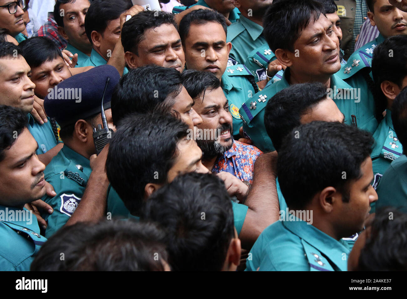 Bangladeshi policemen escort expelled Awami Jubo League leader Ismail Hossain Chowdhury Samrat to the Metropolitan Magistrate court in Dhaka.Former Jubo League leader Ismail Hossain Samrat, an alleged kingpin of the illegal casino business in the capital, was placed on 10-day remand in two cases filed under the arms and narcotics control acts. Stock Photo