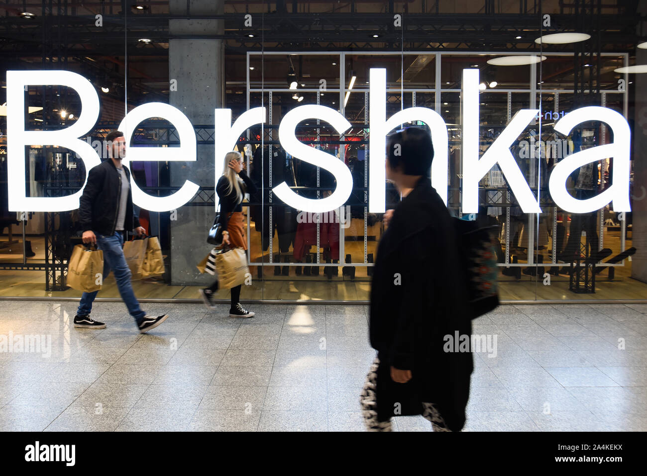 People walk past a Spanish clothing store Bershka Stock Photo - Alamy