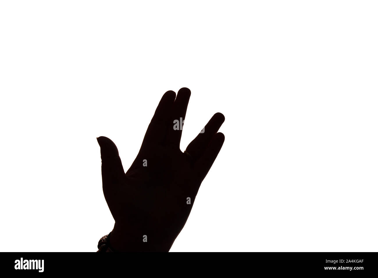 A single left hand in silhouette against a white background, in the position of a vulcan salute from Star Trek Stock Photo