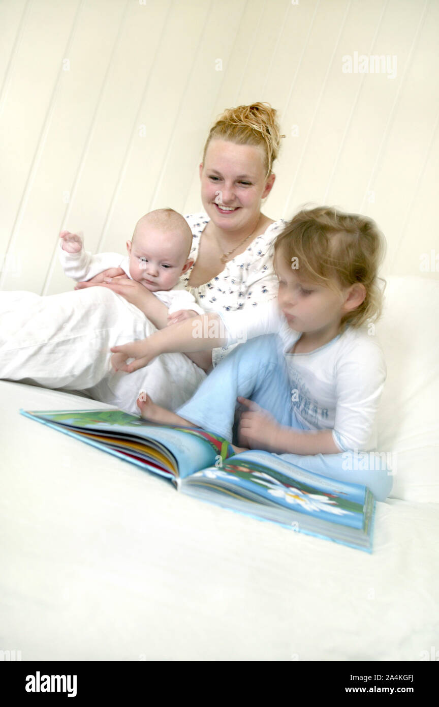 Mother reading book with kids Stock Photo