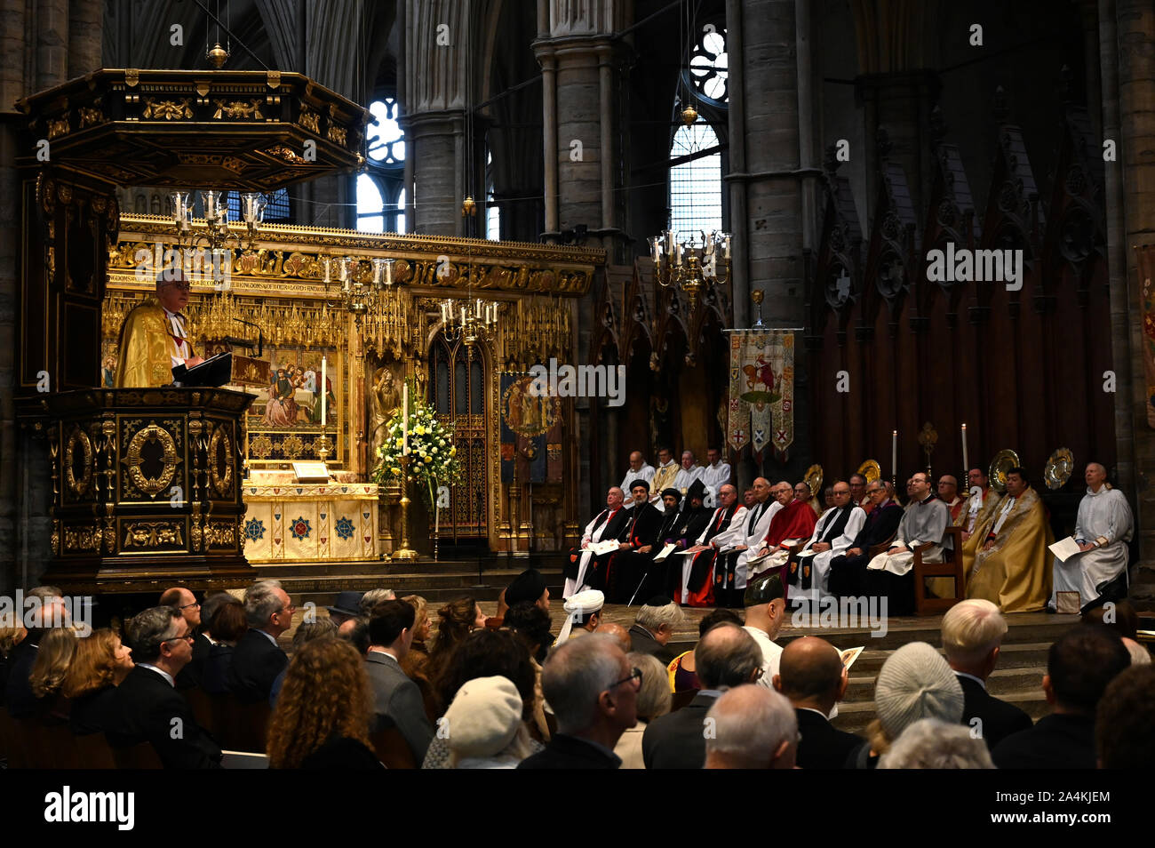 Dean of Westminster John Hall (left) addresses a service at Westminster Abbey in London to mark 750 years since Edward the Confessor's original church was rebuilt under the reign of King Henry III. Stock Photo