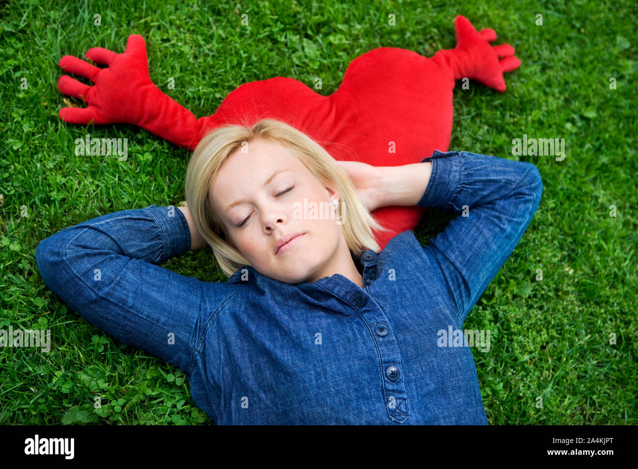Woman with closed eyes relaxing on lawn Stock Photo - Alamy