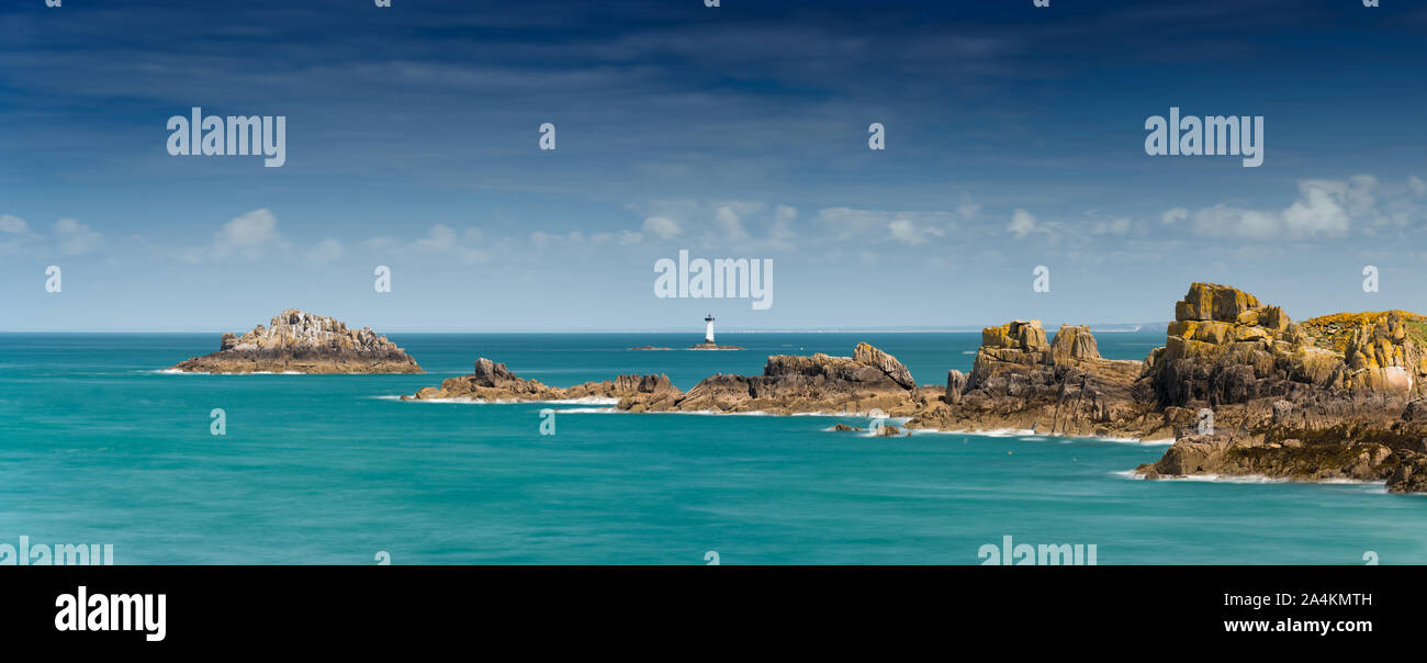 Panorama view of the rocks and reefs on the Normandy coast at low tide with the Pierre de Herpin lighthouse Stock Photo
