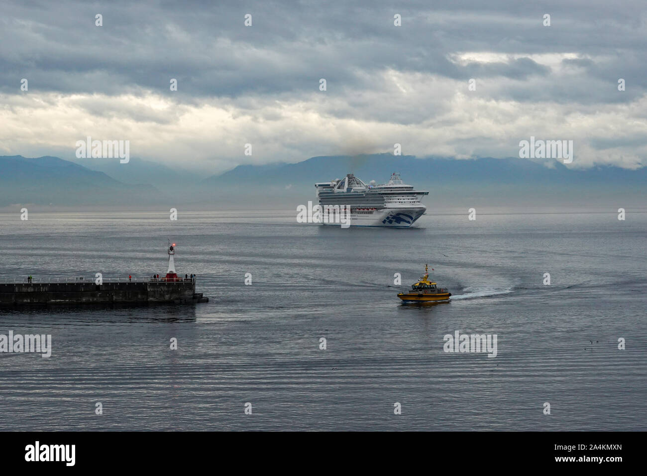 Victoria/Canada-9/14/19: A pilot boat escorts a cruise ship into or out of port from the ocean channel. Stock Photo