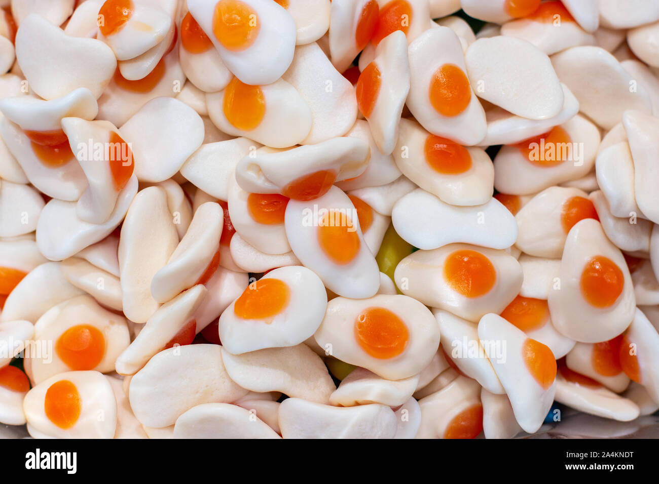 Sweet marmalade in the shape of fried eggs, closeup background