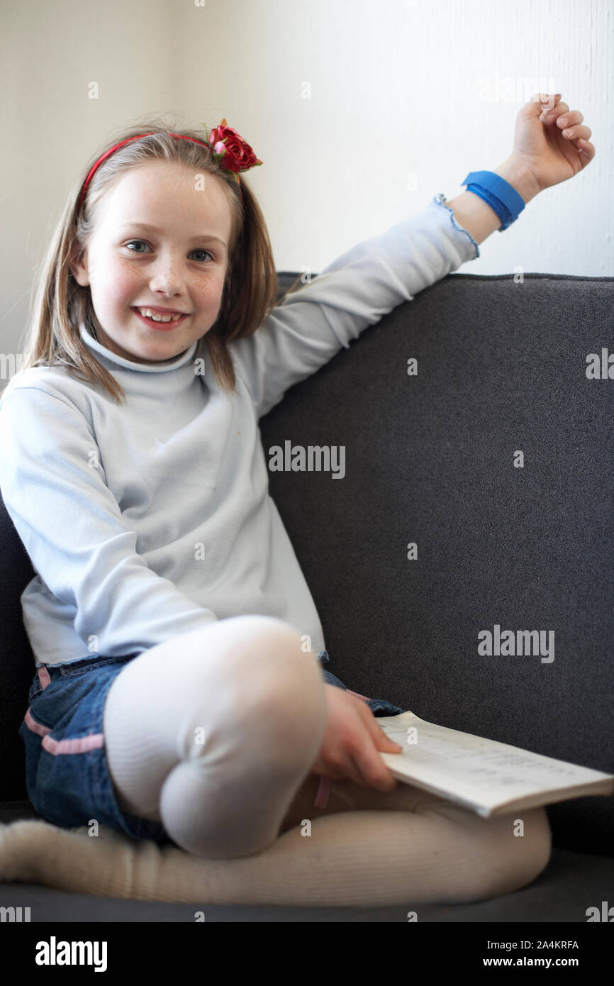 4-Year old girl wearing denim shorts over wool tights Stock Photo