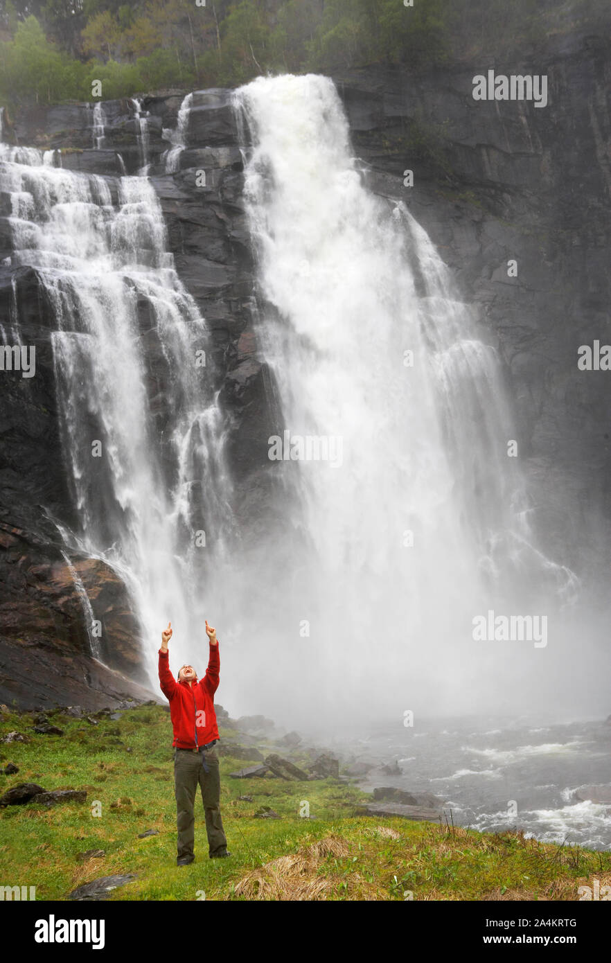 Man In Red Shirt Pointing Upwards At Fendefossen Myrkdalen Close To Vikafjellet Norway Stock Photo Alamy
