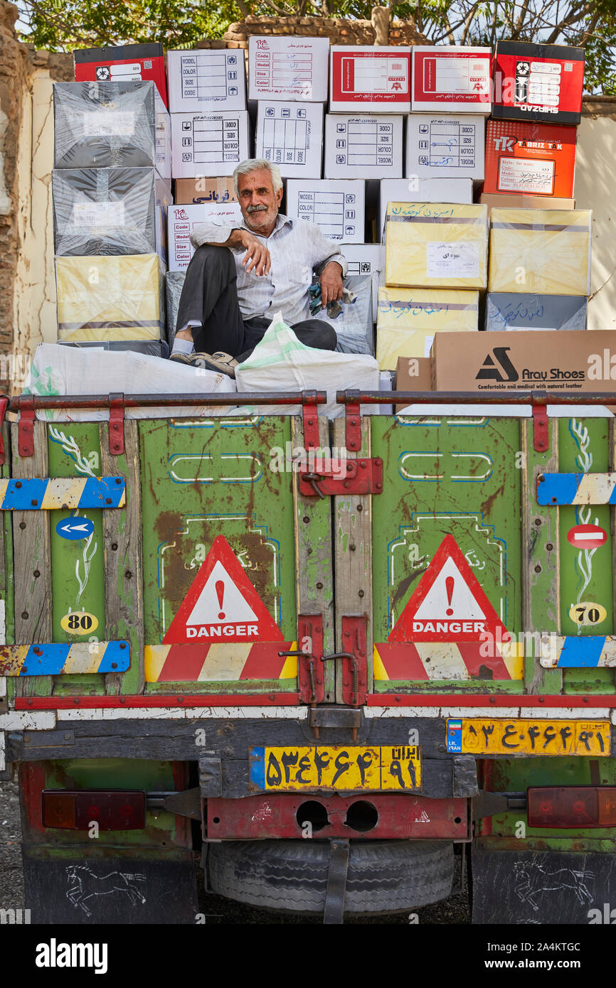 A man sitting in front of the bazaar in the center of the Iranian city of Tabriz in the northwest of the country on the loading area of a truck, taken on 30.05.2017. The bazaar is one of the largest and most impressive of Iran and is famous for its large covered architecture, its variety and quality of handicrafts and carpets. It is located in the center of the city. after the city is also called the fine hand-knotted Persian carpet Tabris. | usage worldwide Stock Photo