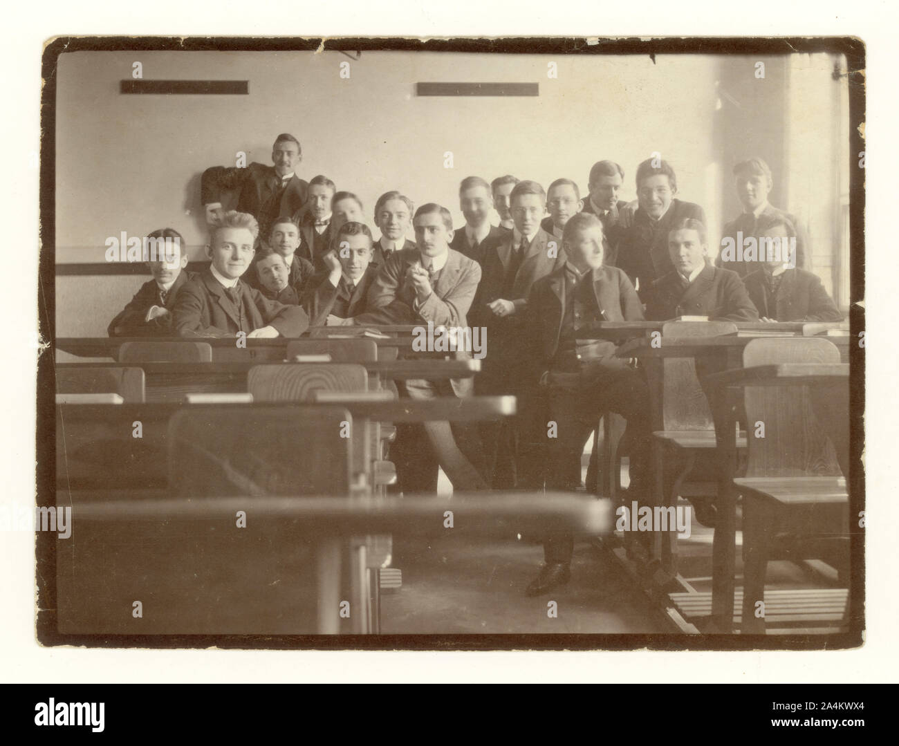 Early 1900's photo of happy young men, students in classroom possibly at a German university, one of the students is English, the rest have German names. circa 1910. Stock Photo