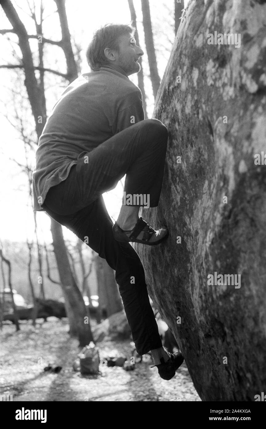 Man climbing a rock Stock Photo - Alamy