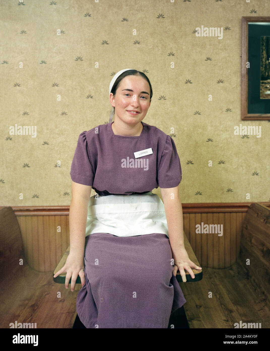 Amish girl in USA working as a waiter in her Rumspringa Stock Photo