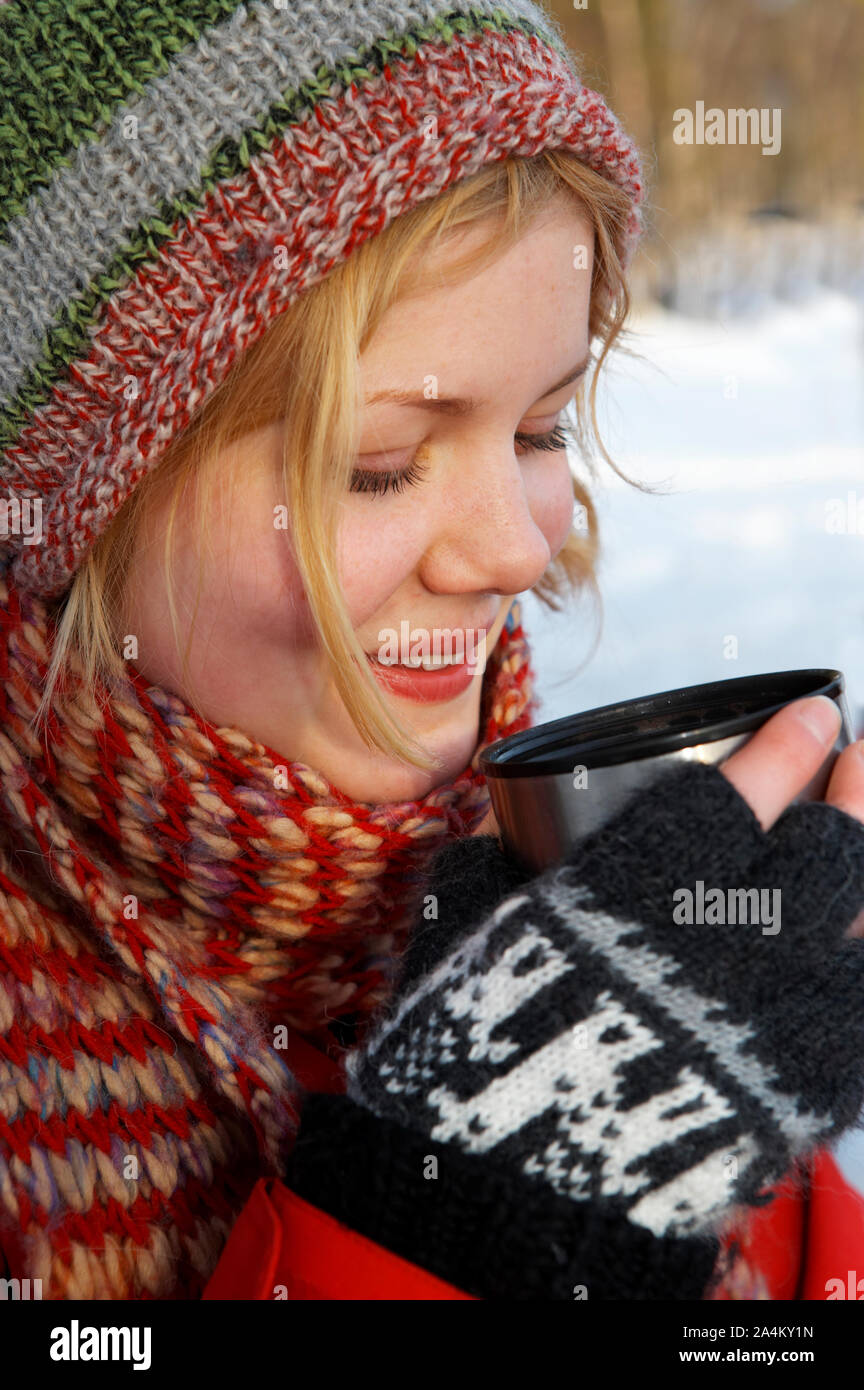 Young woman drinking outdoors Stock Photo