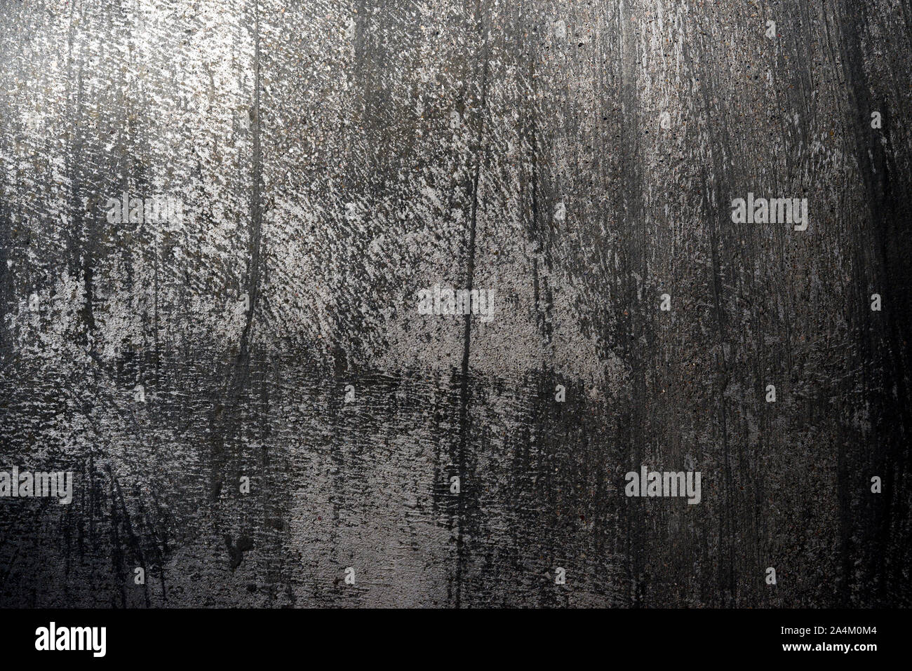 Old cemented wall with black and gray rough texture, rough background Stock Photo