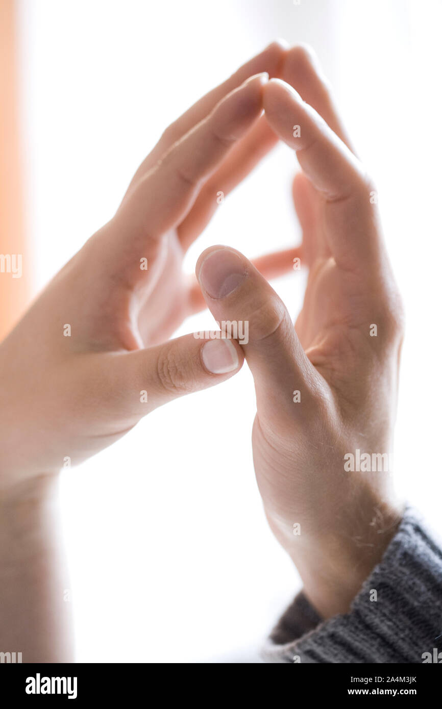 Couple's hands touching Stock Photo