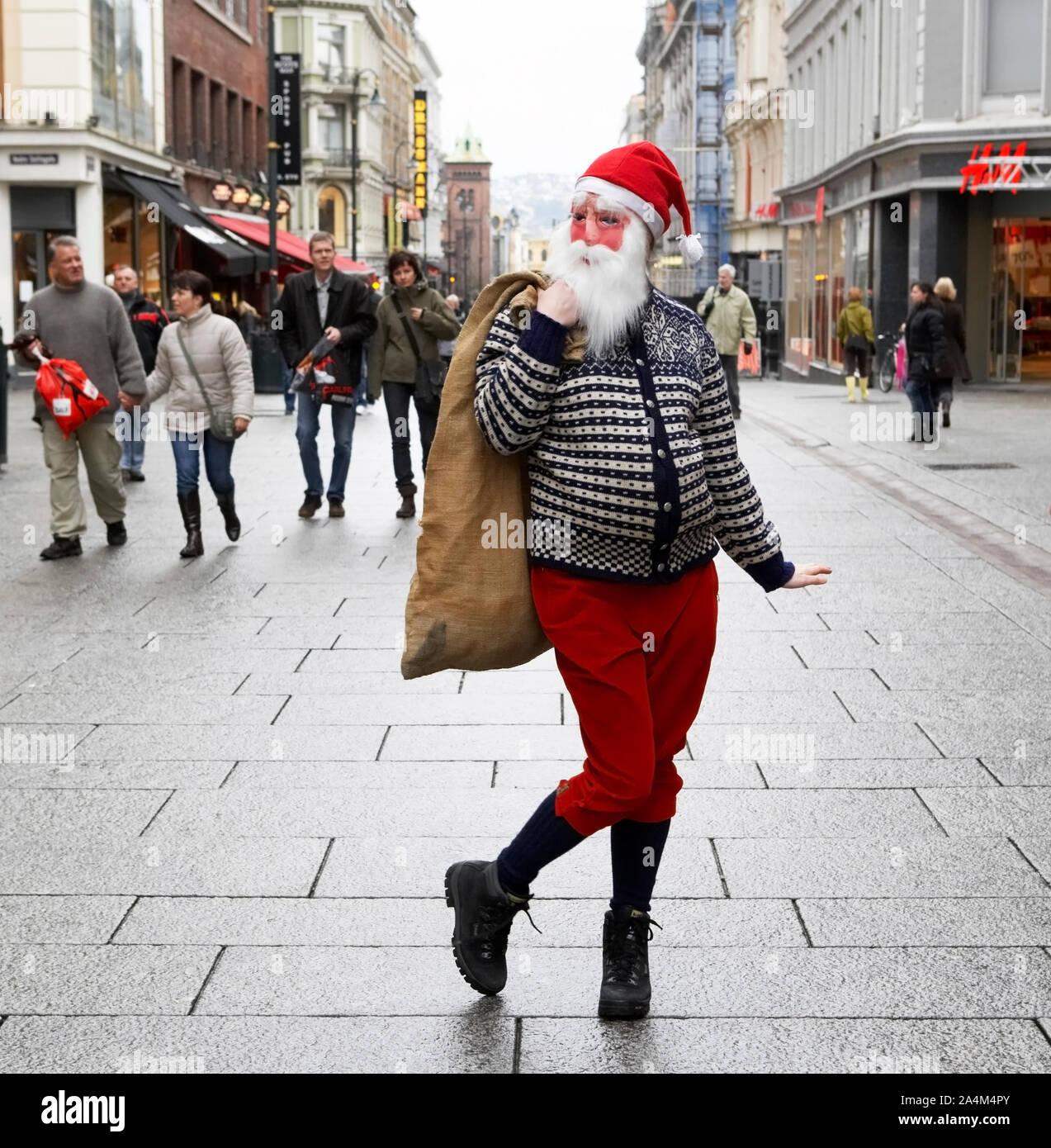 Urban female Santa Claus. Walking in street. With sack Stock Photo