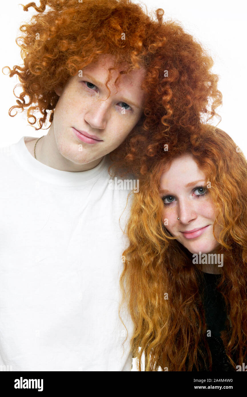 Boy and girl with curly long red hair. Stock Photo