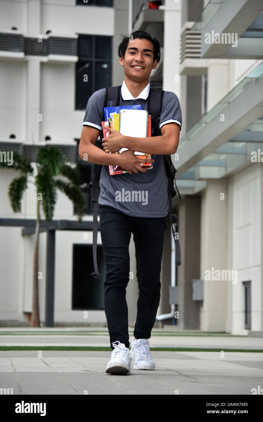 Smiling Young Minority Male Student Walking On Campus Stock Photo - Alamy