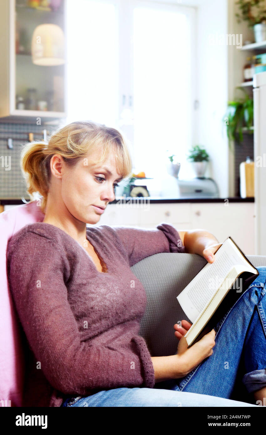 Woman blonde hair sitting on hi-res stock photography and images - Alamy