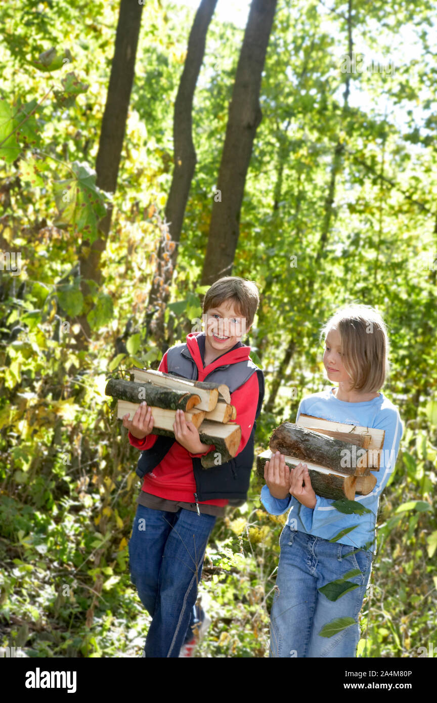 Children carrying firewood - helpful Stock Photo - Alamy