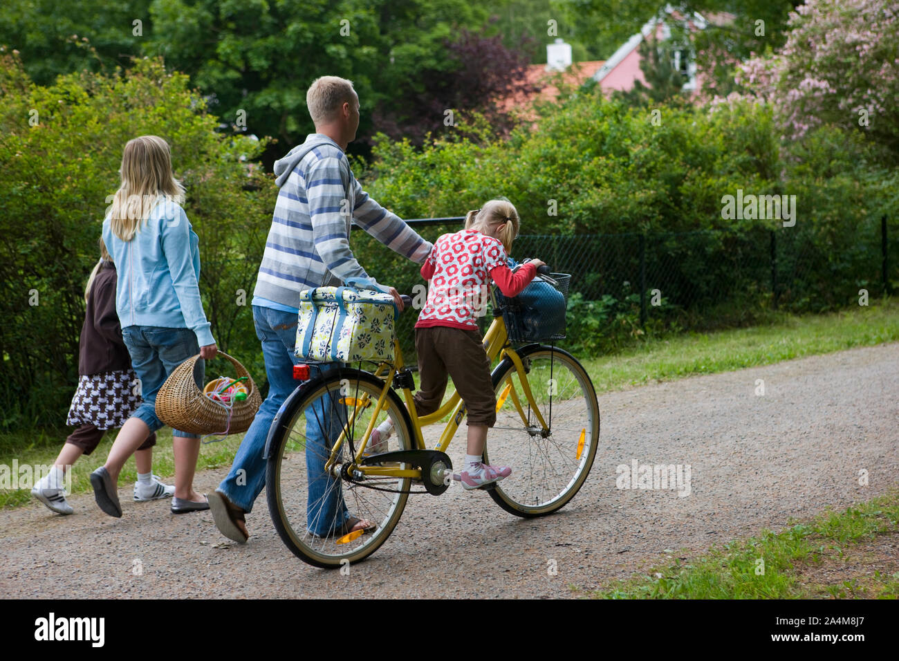 Family strolling with bike Stock Photo