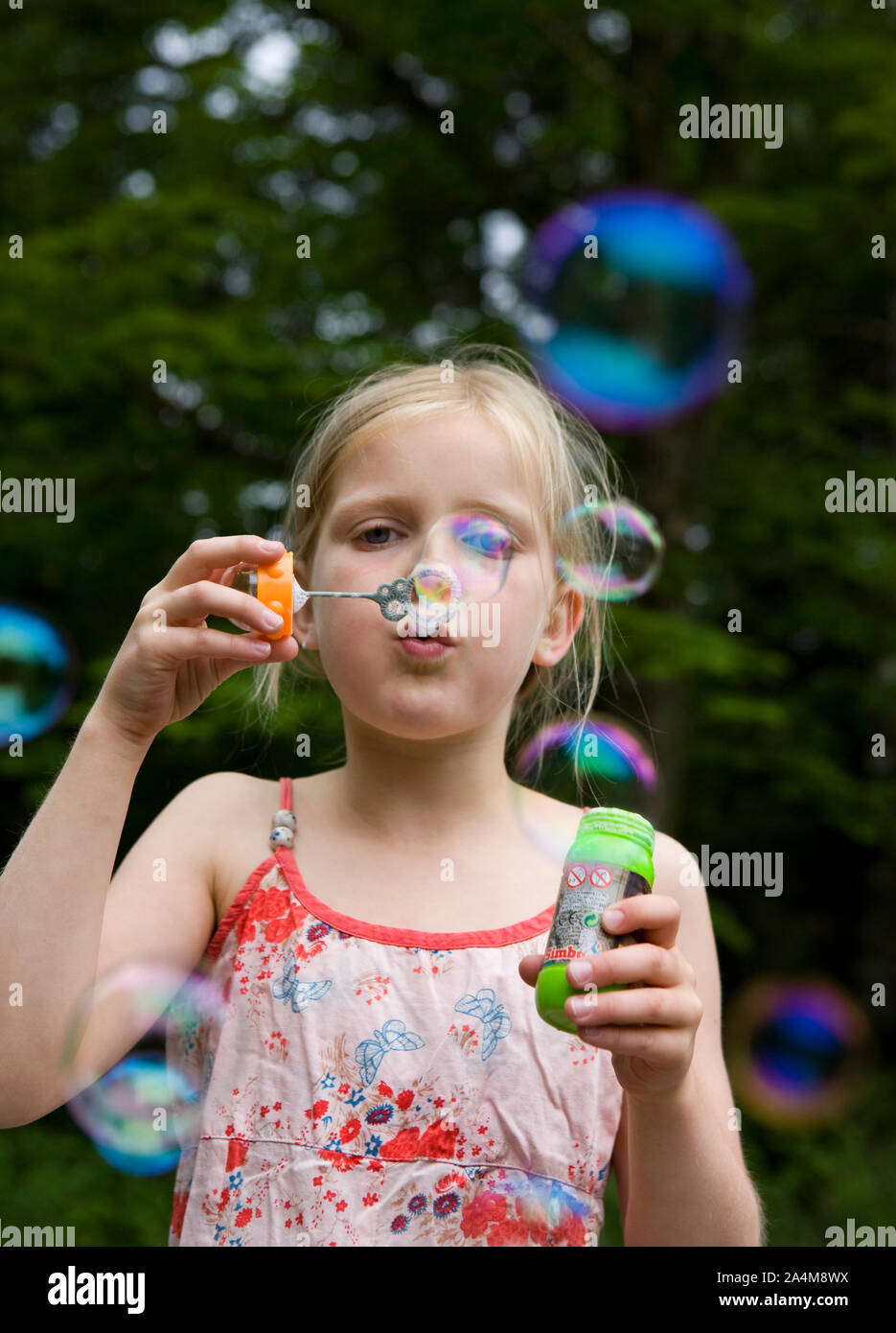 Girl blowing soap bubbles Stock Photo - Alamy