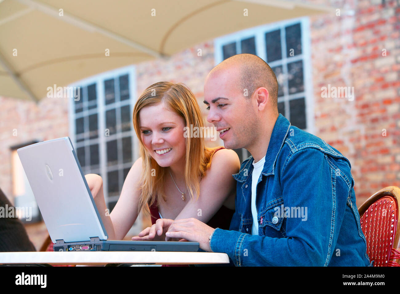 Young lady and man with laptop Stock Photo