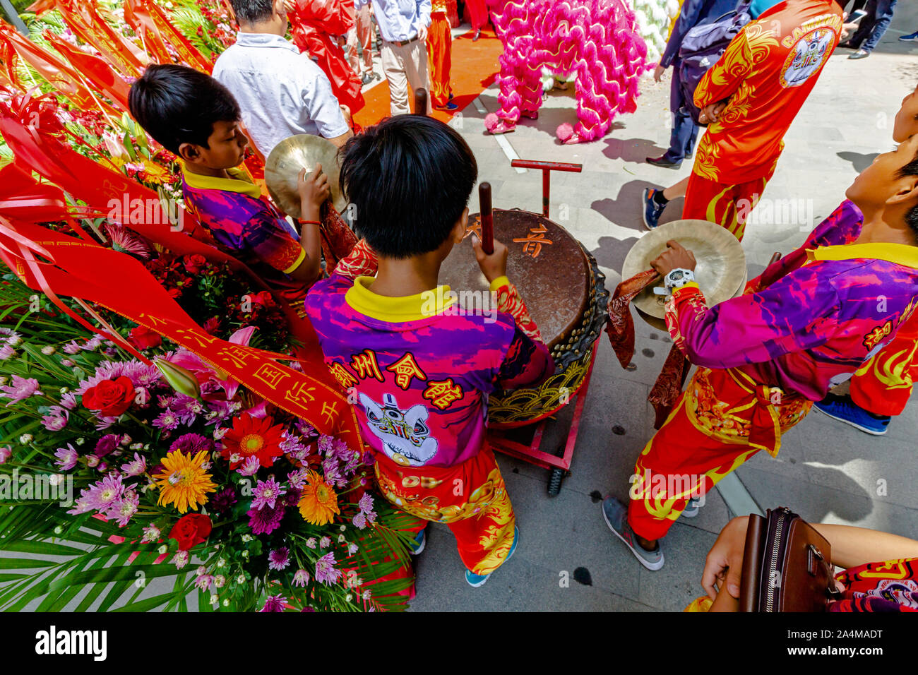 A group of young boys are playing traditional Chinese drums at a new Chinese retail store opening in Olympic Mall in Phnom Penh, Cambodia. Stock Photo