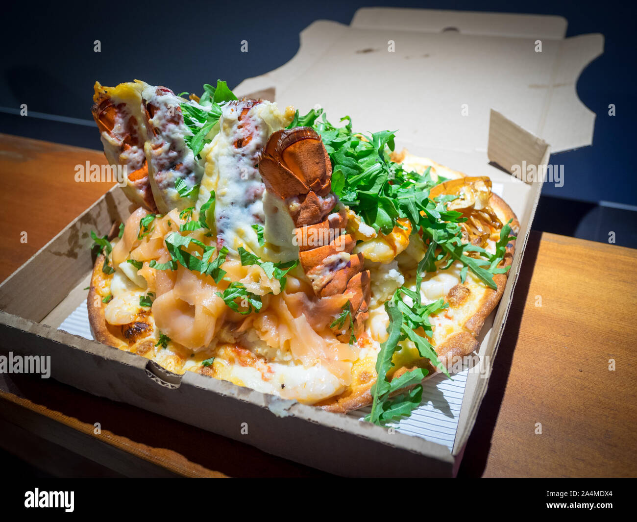 A serpent pizza (lobster tails, smoked salmon, prawns, shrimp) from Steveston Pizza Company in Steveston Village, Richmond, British Columbia, Canada. Stock Photo