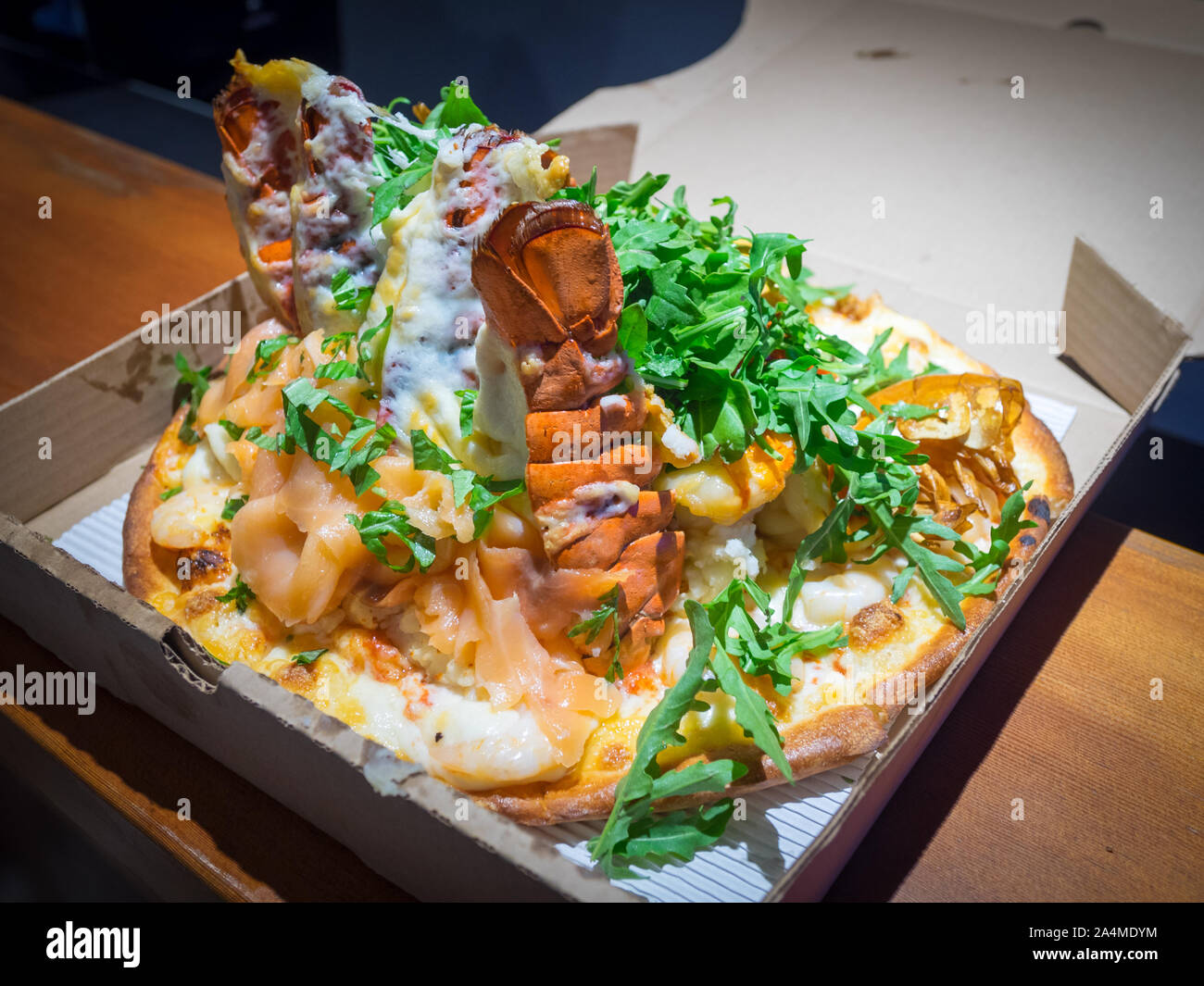 A serpent pizza (lobster tails, smoked salmon, prawns, shrimp) from Steveston Pizza Company in Steveston Village, Richmond, British Columbia, Canada. Stock Photo