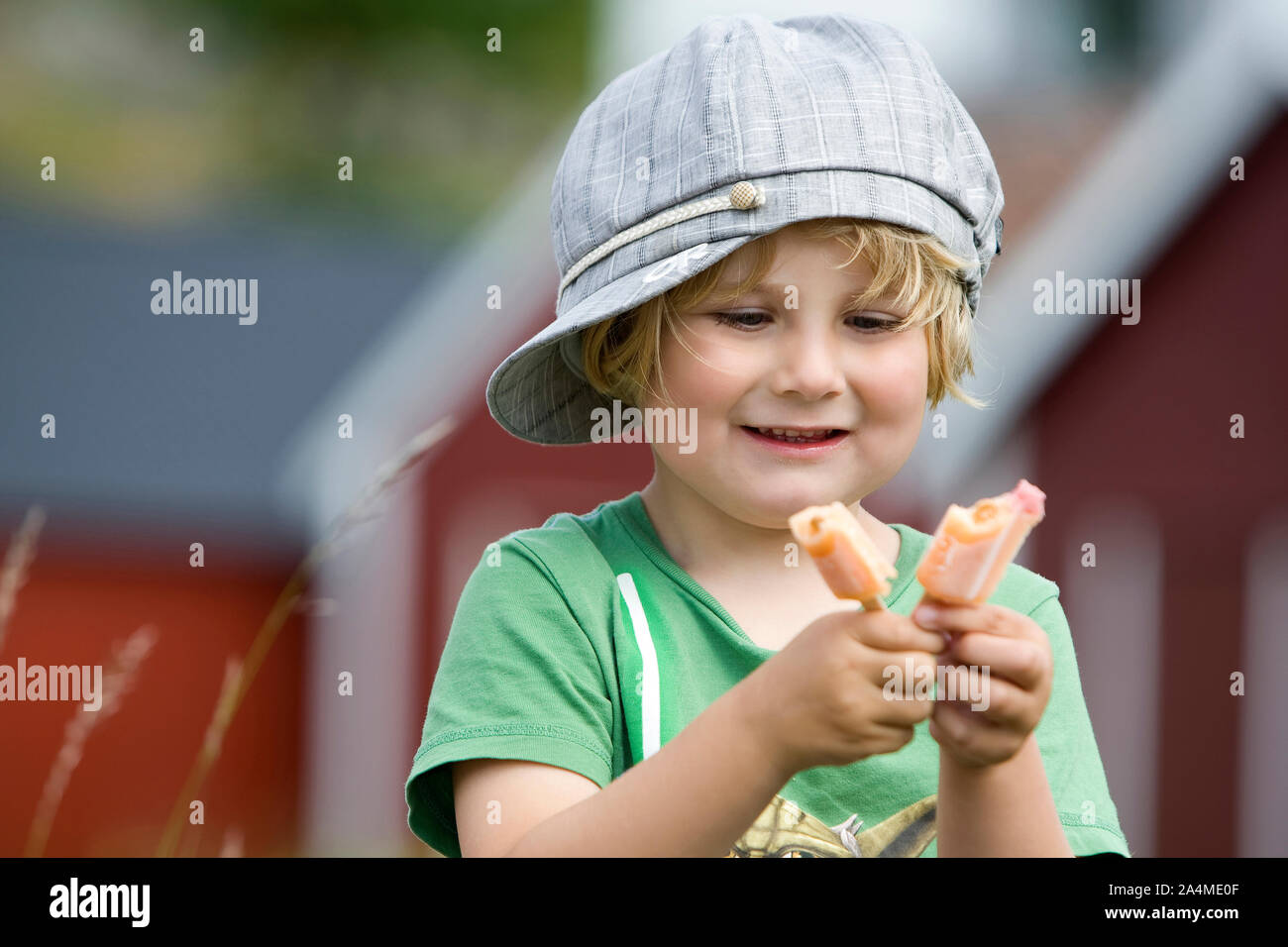 Portrait of boy holding frozen popsicle Stock Photo