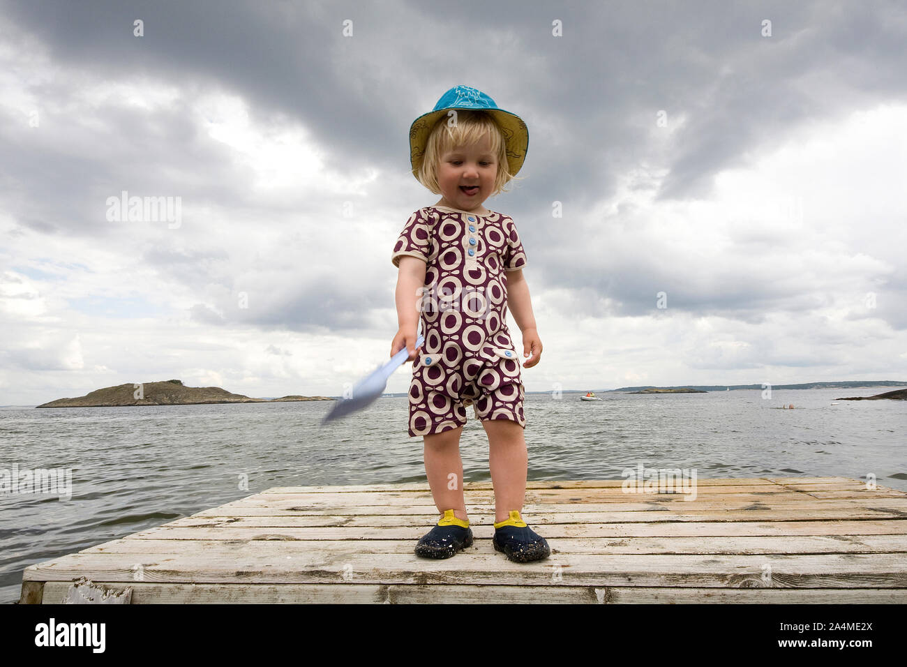 Portrait of child on pier at beach Stock Photo