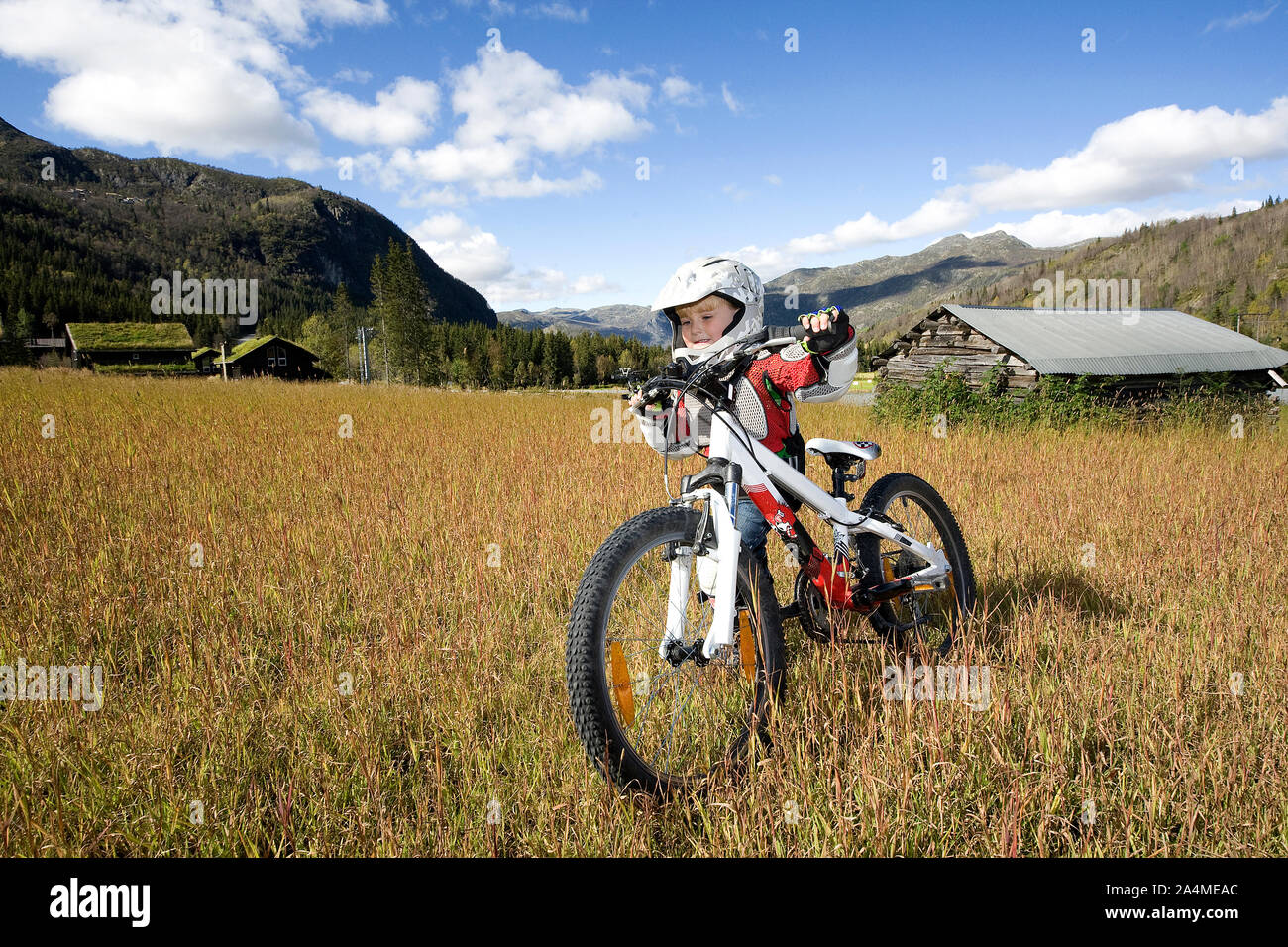 Boy Mountain Biking At Rural Landscape Stock Photo