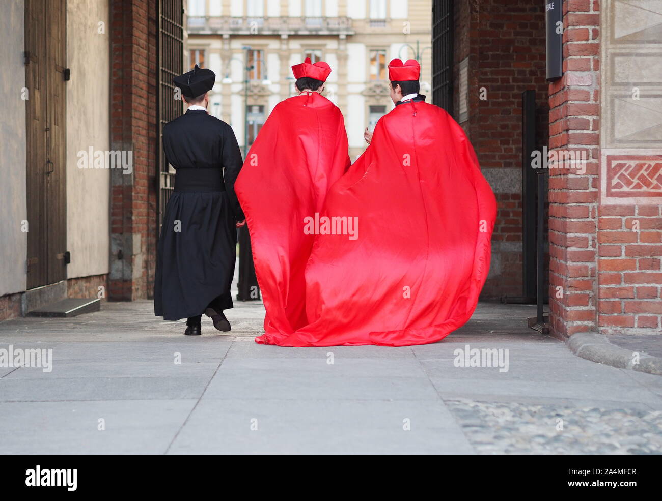People in carnival outifts posing and walking for photographers in Milan during carnival parade. Stock Photo