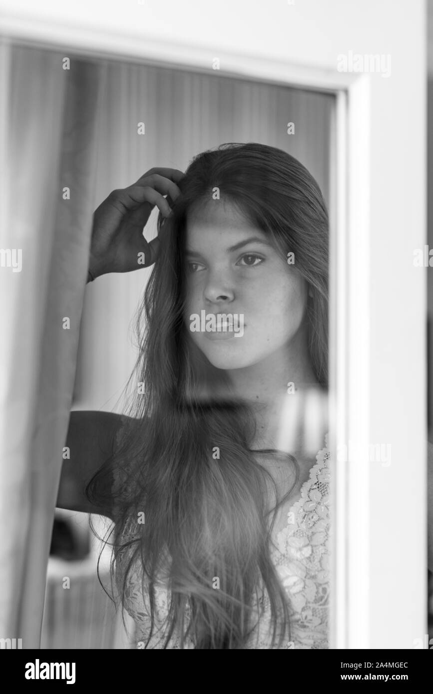 Woman holding hand in hair Stock Photo